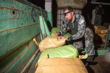 Petty Officer Leslie Floyd numbers parcels of seized drugs as HMAS Warramunga’s boarding team conduct an illicit cargo seizure. Courtesy: Royal Australian Navy