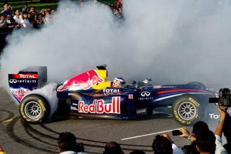 Daniel Ricciardo does burn outs in his Red Bull car on a road near the India Gate monument at Rajpath in New Delhi. Fans may be deprived of the Indian Grand Prix next season. Manan Vatsyayana / AFP