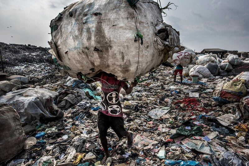 Kadir van Lohuizen took first place in the 'Environment - Stories' category with this image from a story that shows a man as he carries a huge back of pet bottles collected for recycling at the Olusosun landfill in Lagos, Nigeria. EPA/KADIR VAN LOHUIZEN/NOOR IMAGES