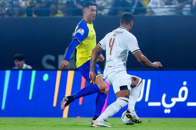 Cristiano Ronaldo is marked by Al Shabab's Iago Santos. AFP