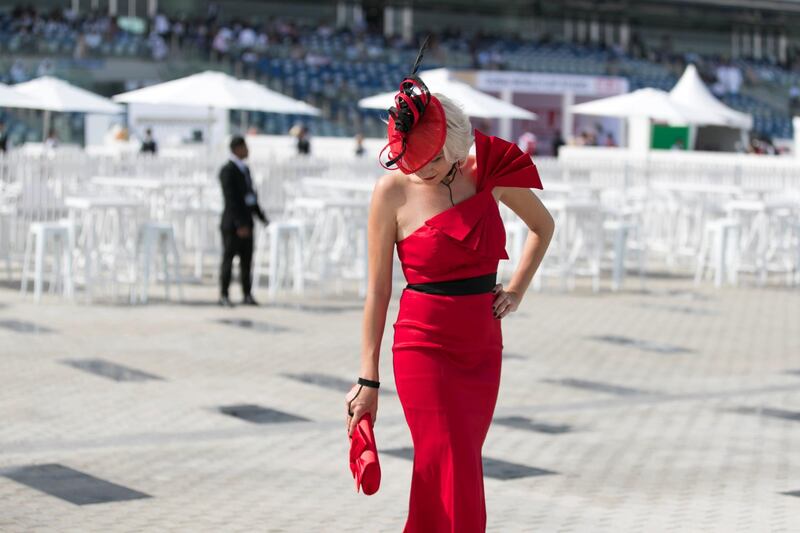 DUBAI, UNITED ARAB EMIRATES - MARCH 31, 2018. 

A women in red at Dubai World Cup 2018.

(Photo by Reem Mohammed/The National)

Reporter: 
Section: NA