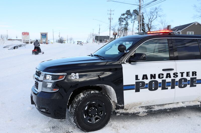 A snowmobile drives past a police checkpoint in Buffalo. Reuters