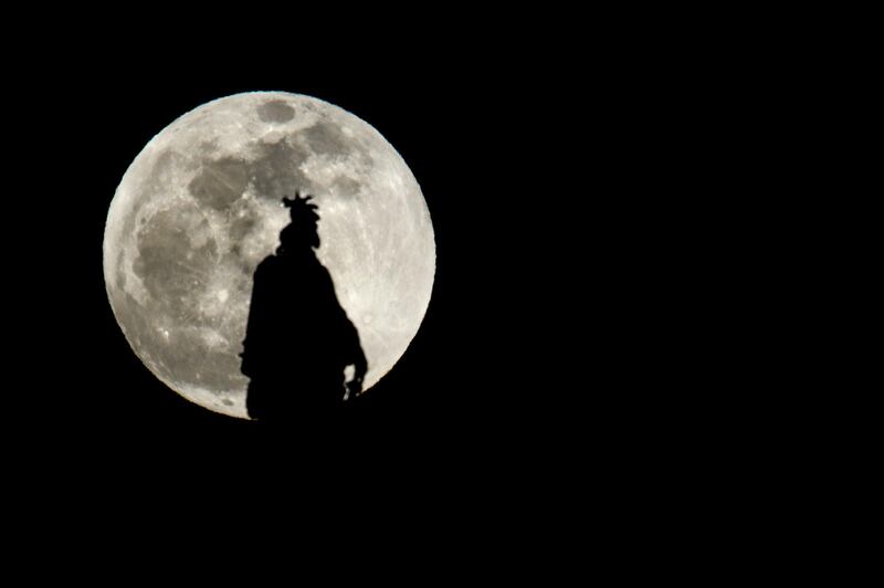 The Statue of Freedom on top of the US Capitol dome is seen silhouetted against the super moon on January 20, 2019 in Washington, DC. AFP