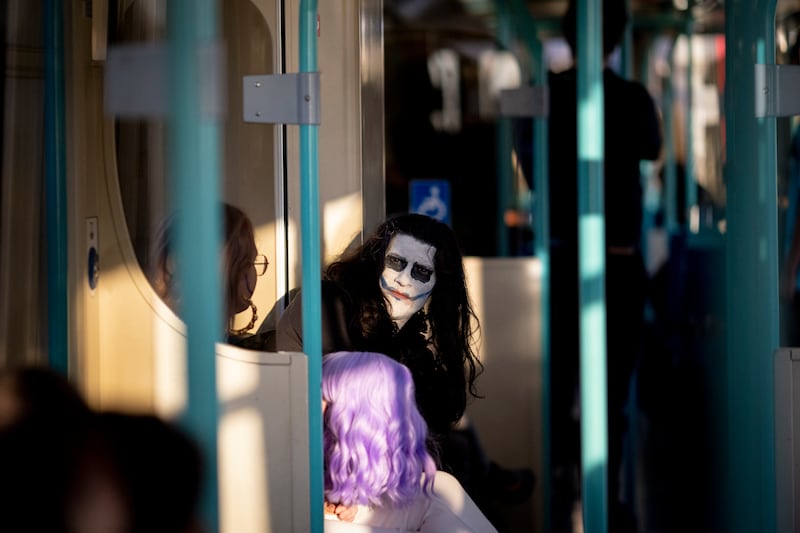 A cosplayer dressed as Joker travels on a DLR train after attending London's MCM Comic Con. EPA