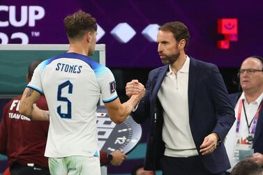 Soccer Football - FIFA World Cup Qatar 2022 - Round of 16 - England v Senegal - Al Bayt Stadium, Al Khor, Qatar - December 4, 2022 England's John Stones with manager Gareth Southgate after being substituted REUTERS / Wolfgang Rattay