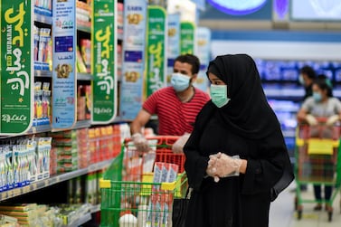 A couple wearing protective face masks shop at a supermarket in Doha, Qatar. EPA