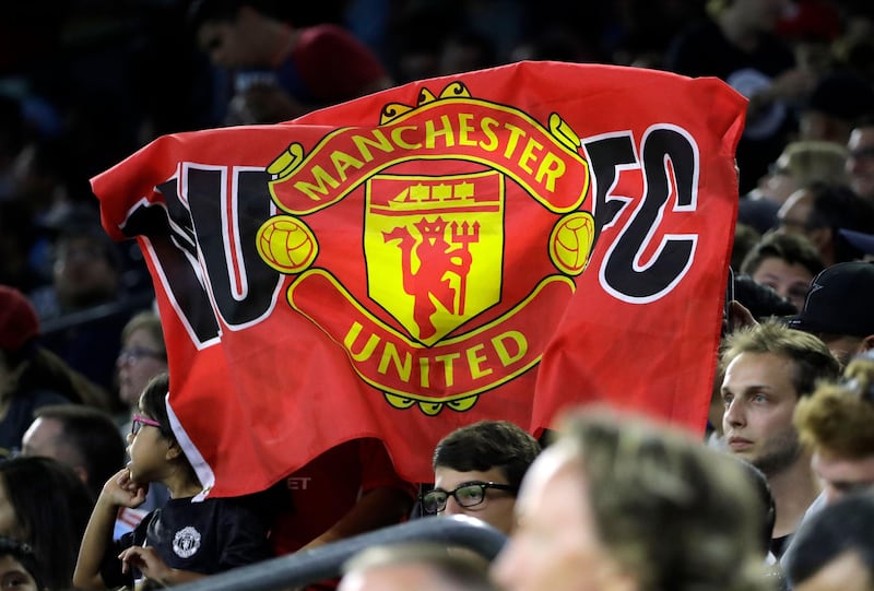 A fan holds up a flag in support of Manchester United before an International Champions Cup soccer match against Manchester City in Houston, Thursday, July 20, 2017. David J. Phillip / AP Photo
