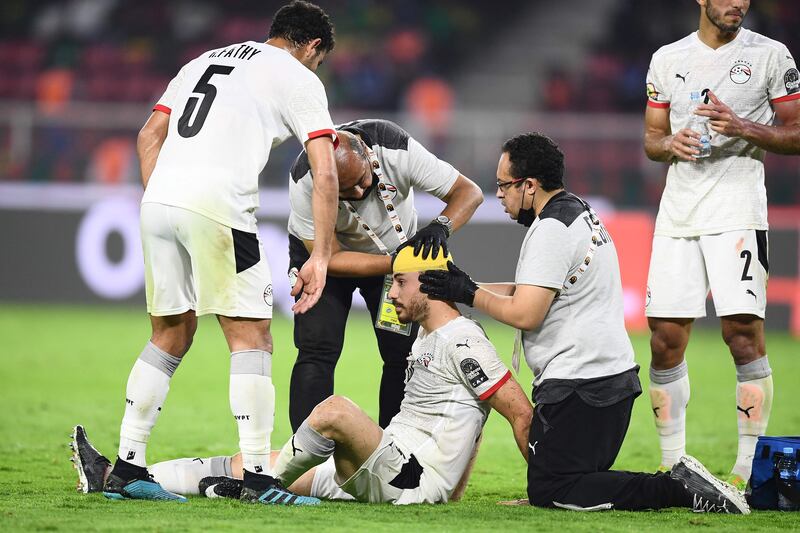Egypt's defender Mahmoud 'El Wensh' Hamdy receives treatement on a head injury. AFP