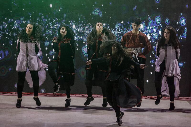 epa08042306 Palestinians dance Dabka as they a ceremony of lighting a Christmas tree in Gaza City, 03 December 2019. The event was organised by the YMCA Gaza.  EPA/MOHAMMED SABER