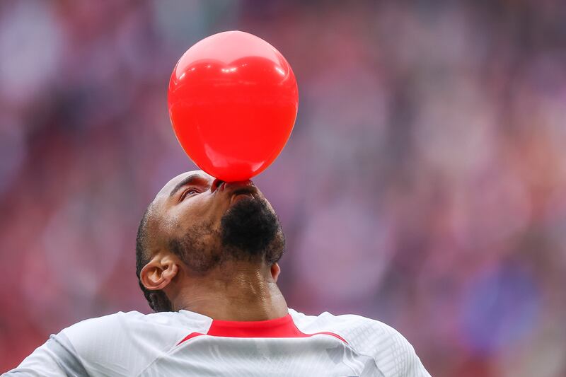 RB Leipzig's Christopher Nkunku inflates a balloon as he celebrates scoring against Hoffenheim in a Bundesliga match in Leipzig, Germany. AP