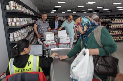 People get food aid at the market of AFAD, the Turkish Disaster and Emergency Management Presidency in Nurdagi district of Gaziantep. EPA