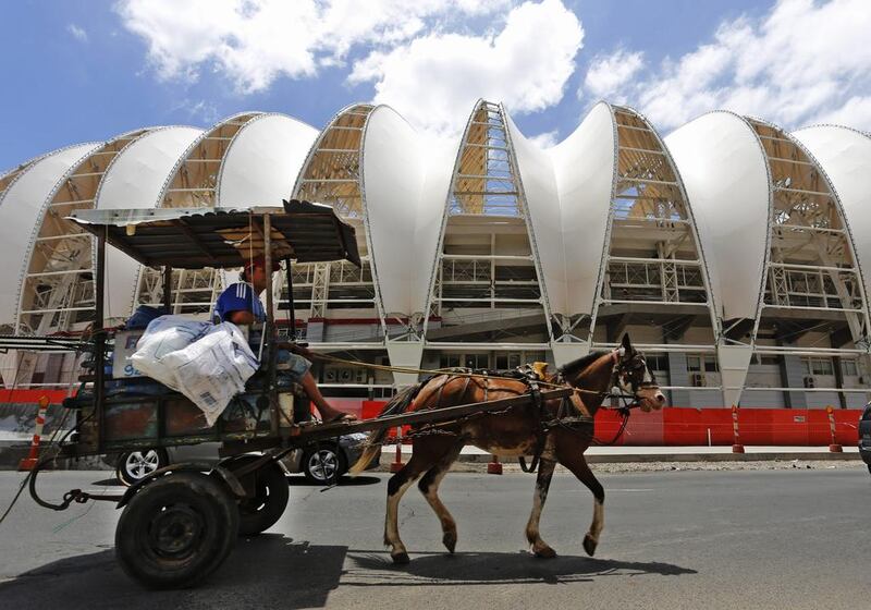 This December 12, 2013 file photo shows a horse carriage passing the Estadio Beira-Rio in Porto Alegre, Brazil. Ferdinand Ostrop / AP 