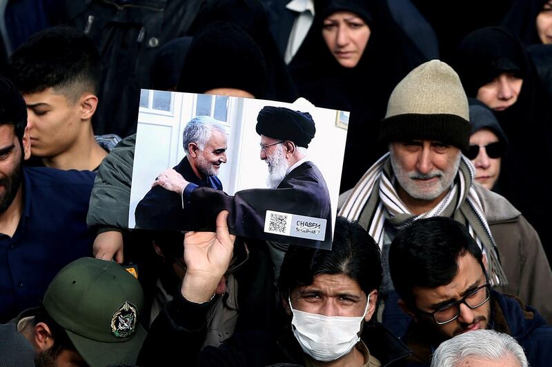 A demonstrator holds a picture of Ayatollah Ali Khamenei with Iranian Major-General Qassem Suleimani, during protest against the assassination of Suleimani and Iraqi militia commander Abu Mahdi Al Muhandis in Tehran, Iran. Reuters