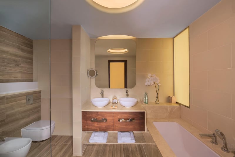 <p>The bathrooms have dual basins, a shower and separate tub. Courtesy The Retreat Palm Dubai MGallery by Sofitel&nbsp;</p>
