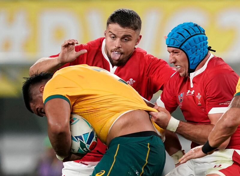 Allan Alaalatoa, left, of Australia is challenged by Wales' players Nicky Smith and Justin Tipuric at the Tokyo Stadium. EPA