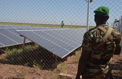 A member of the Nigerian Military is stationed in front of solar panels that pump borehole water to irrigate the site of the Irhazer project, financed by France near Agadez, in the northern desert of Niger, in 2019. AFP