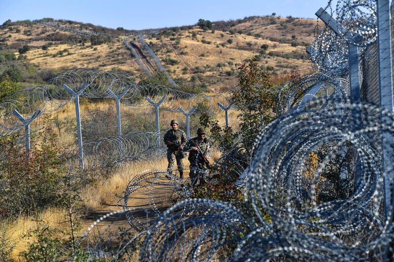 epa08046476 Macedonian soldiers patrol the Macedonian border with Greece, near Gevgelija, Republic of North Macedonia on 13 September 2019 (issued on 05 December 2019). Although the Balkan migrant route has been officially closed since 03 March 2016, small groups of migrants are still illegally passing the border between Greece and North Macedonia on their way to western Europe. Some travel this road by foot, while others use the transport offered by migrant smugglers. Beside the North Macedonian police and army, the border with Greece is being patrolled by police forces from other European countries.  EPA/GEORGI LICOVSKI  ATTENTION: This Image is part of a PHOTO SET