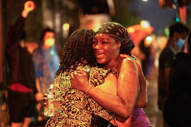 Shawanda Hill (R), the girlfriend of George Floyd reacts near the spot where he died while in custody of the Minneapolis Police in Minneapolis, Minnesota.   AFP