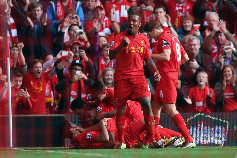 LIVERPOOL, ENGLAND - OCTOBER 20:  Raheem Sterling of Liverpool celebrates with his team-mates after scoring the opening goal during the Barclays Premier League match between Liverpool and Reading at Anfield on October 20, 2012 in Liverpool, England.  (Photo by Clive Brunskill/Getty Images)