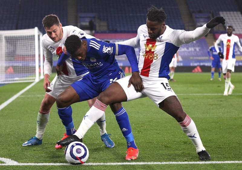 Crystal Palace's Joel Ward, left, Crystal Palace's Jeffrey Schlupp, right, and Leicester's Kelechi Iheanacho challenge for the ball during the English Premier League soccer match between Leicester City and Crystal Palace at the King Power Stadium in Leicester, England, Monday, April 26, 2021. (Alex Pantling/Pool via AP)