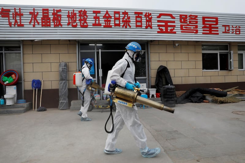 Volunteers from the Blue Sky Rescue team, in protective suits, disinfect the Nangong comprehensive market following a new outbreak of the coronavirus disease (COVID-19) in Beijing, China, June 18, 2020. Picture taken June 18, 2020. REUTERS/Carlos Garica Rawlins