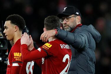 Liverpool manager Jurgen Klopp celebrates with Andrew Robertson and Trent Alexander-Arnold after the West Ham match. Reuters