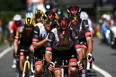 A photograph taken on July 10, 2022 shows UAE Team Emirates team's New Zealander rider George Bennett leading his teammates as they cycle during the 9th stage of the 109th edition of the of the Tour de France cycling race, 192,9 km between Aigle in Switzerland and Chatel Les Portes du Soleil in the French Alps.  - UAE Team Emirates team's New Zealander rider George Bennett has withdrawn from the race before the start of the 10th stage in Morzine in the French Alps, due to a positive Covid-19 test result on July 12, 2022.  (Photo by Anne-Christine POUJOULAT  /  AFP)