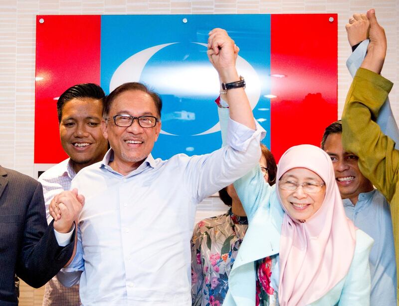 Malaysia's prime minister-in-waiting Anwar Ibrahim, left, poses with his wife Deputy Prime Minister Wan Azizah Wan Ismail after a press conference at the People's Justice Party headquarters in Petaling Jaya, Malaysia, Friday, Sept. 21, 2018. Anwar said that he has no reason to doubt his former political nemesis will hand over the leadership position within two years as planned after sorting out deep-seated issues like corruption. (AP Photo/Yam G-Jun)