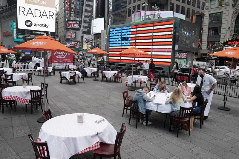 A server talks to guests at a pop up restaurant set up in Times Square for 'Taste of Times Square Week' during the coronavirus disease (Covid-19) pandemic in the Manhattan borough of New York City. Reuters