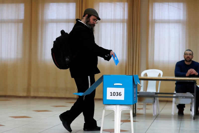 A man prepares to cast his ballot in the Israeli settlement of Nokdim, in the occupied West Bank. REUTERS