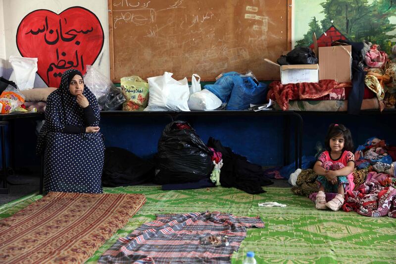 Families moved what belongings they could salvage from the rubble of their homes to the UNRWA school where they are sheltering. AFP