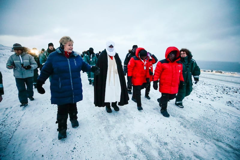 Norway's Prime Minister Erna Solberg, left, and Agriculture and Food Minister Olaug Bollestad, right, as they escort Ghanaian President Nanna Addo Dankwa Akufo-Addo, centre left, during their visit to the Svalbard's global seed vault. NTB scanpix via AP