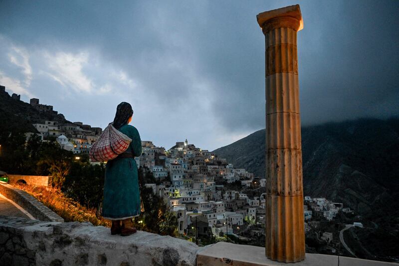 A woman looks at the hillside village of Olympos, home to one of the few matriarchal societies in Greece that resists tourism and lifestyle standardisation. AFP