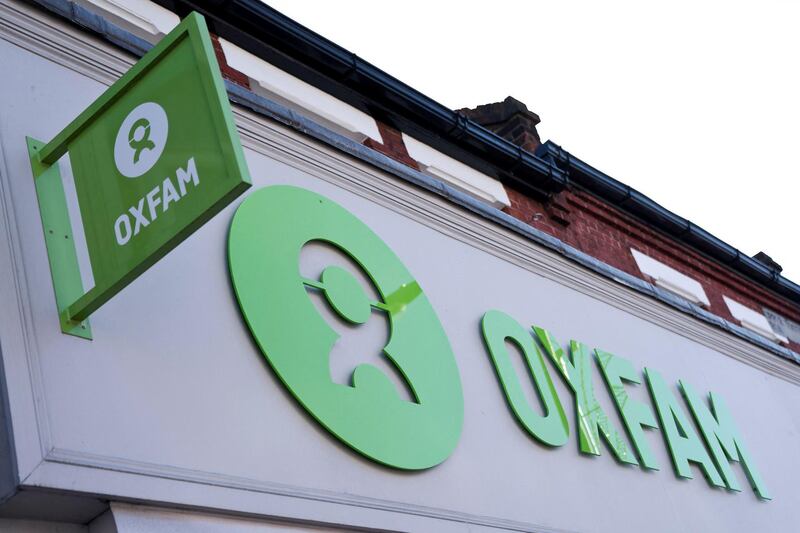 'Oxfam' signage is pictured outside a high street branch of an Oxfam charity shop in south London on February 17, 2018. - Oxfam fired four staff members for gross misconduct and allowed three others to resign following an internal inquiry into what happened in Haiti in 2011. (Photo by Justin TALLIS / AFP)