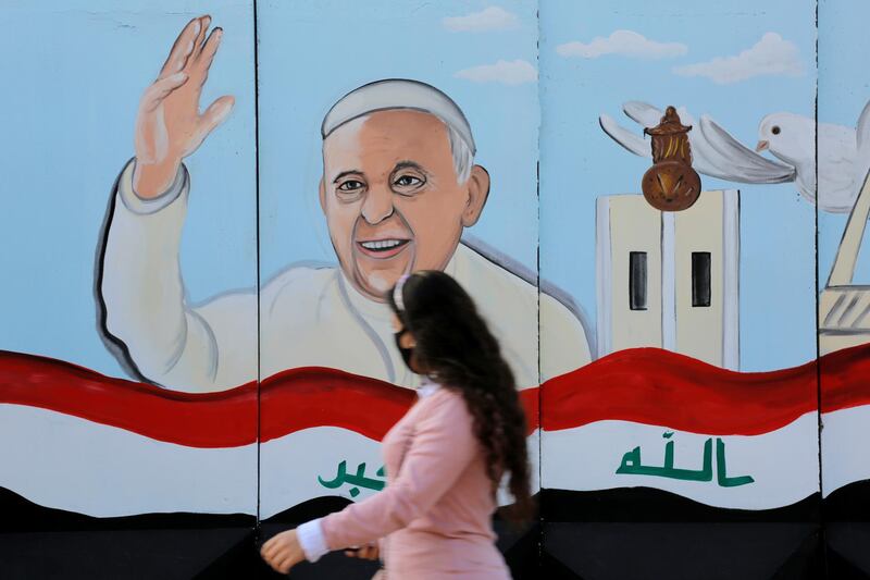 A mural of Pope Francis is seen on the wall of a church upon his upcoming visit to Iraq, in Baghdad, Iraq February 22, 2021. REUTERS/Teba Sadiq