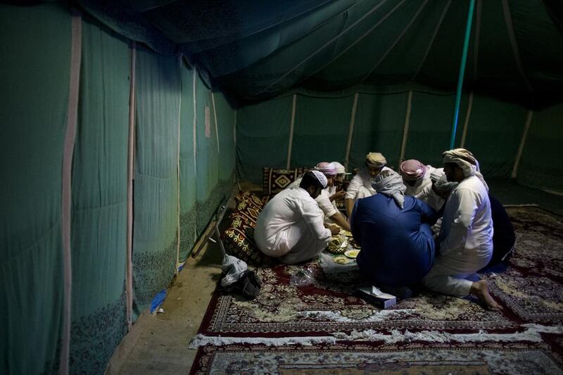 Emirati men eat food together during the Liwa International Festival near. Christopher Pike / The National