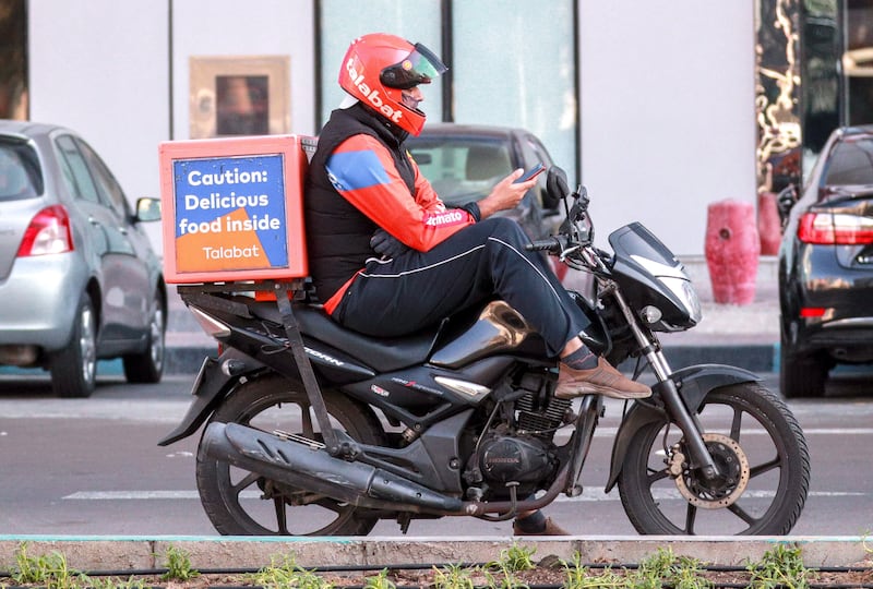 Abu Dhabi, United Arab Emirates, December 15, 2020.  Talabat riders wait for orders on a chilly Tuesday morning at central Abu Dhabi.
Victor Besa/The National
Section:  NA
for:  Standalone/Weather