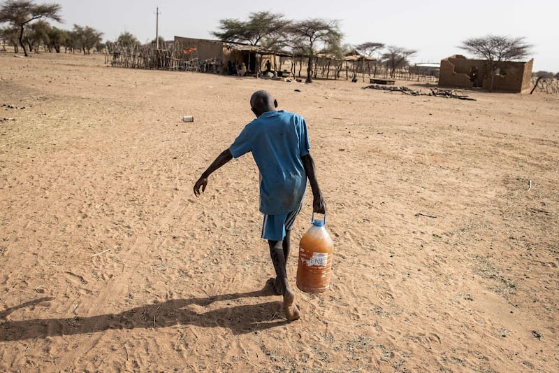 A boy carries a bottle of drinking water to his home in the village of Madina Torobe, in the Matam region of Senegal. Maintaining access to drinking water in the country's north-west is a constant concern. Through the months of November to August no rain will fall, and rivers and natural lakes dry up.  Not all areas have drinking wells and flowing taps. Where they di exist, the water is sometimes dirty or used specifically for animals. Fulani pastoralists and families living in these remote villages sometimes resort to digging large holes in dried river beds in search of cleaner drinking water from themselves and their animals. AFP