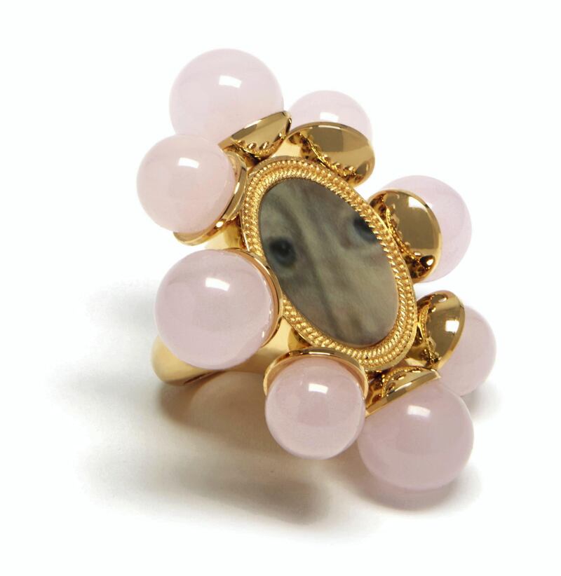 A halo of pink stones give a feminine touch to this gothic piece