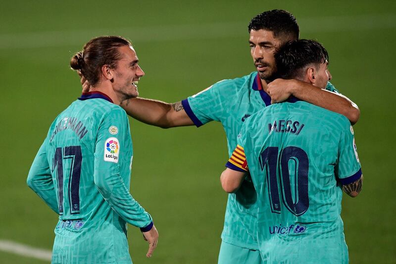 Antoine Griezmann celebrates with Lionel Messi and Luis Suarez. AFP