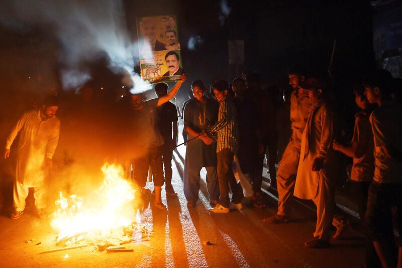 Supporters of former Pakistani Prime Minister Nawaz Sharif burn tyres during a protest ahead of of the arrival of Nawaz from London, in a rally in Lahore. AFP