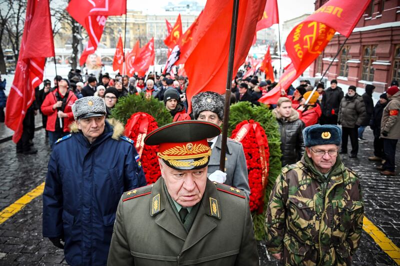 Russian Communist party supporters march to lay flowers to the tomb of Joseph Stalin, marking the 143rd anniversary of his birth, in Red Square, Moscow. AFP