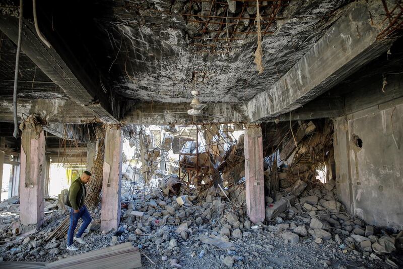 An Iraqi Christian visits a building in Qaraqosh, Iraq, that bears the scars of ISIS violence. Reuters