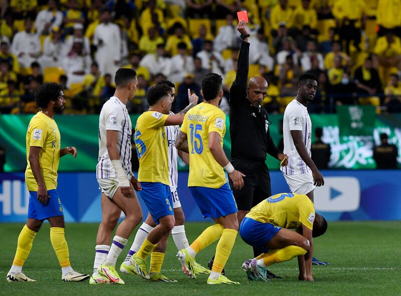 Al Nassr's Aiman Yahya is shown a red card by referee Ahmed Al Kaf. Reuters