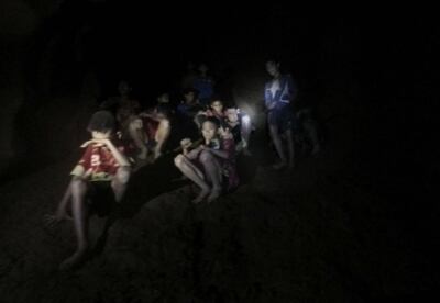 epa06859095 An undated handout photo released by Royal Thai Army on 03 July 2018 shows the missing 13 young members of a youth soccer team including their coach, moments they were found inside the cave complex at Tham Luang cave in Khun Nam Nang Non Forest Park, Chiang Rai province, Thailand. Chiang Rai provincial Governor Narongsak Osatanakorn said on 02 July that all of 13 young members of a youth soccer team including their coach have been  found alive in the cave.  EPA/ROYAL THAI ARMY HANDOUT  HANDOUT EDITORIAL USE ONLY/NO SALES