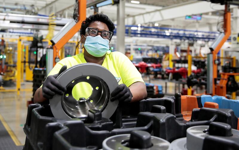 A Dana Inc. assembly technician wears a face mask as she assembles axles for automakers, as the auto industry begins reopening amid the coronavirus disease (COVID-19) outbreak, at the Dana plant in Toledo, Ohio,U.S. REUTERS