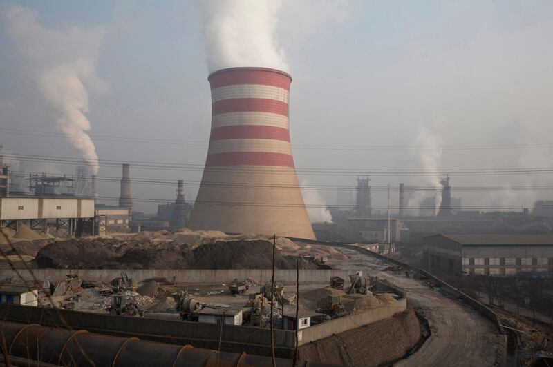 FILE - In this Dec. 30, 2016, file photo, smoke and steam spew from the sprawling complex that is a part of the Jiujiang steel and rolling mills in Qianan in northern China's Hebei province. The Commerce Department is urging President Donald Trump to impose tariffs or quotas on imported aluminum and steel. The recommendations unveiled by Secretary Wilbur Ross on Friday, Feb. 16, 2018, are likely to escalate tensions with China and other U.S. trading partners. (AP Photo/Ng Han Guan, File)