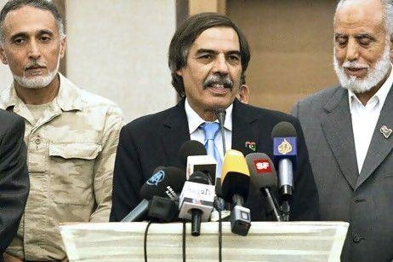 Dr Ali Tarhouni, the rebels' oil minister, at a news conference in Tripoli. Giulio Petrocco / AP Photo