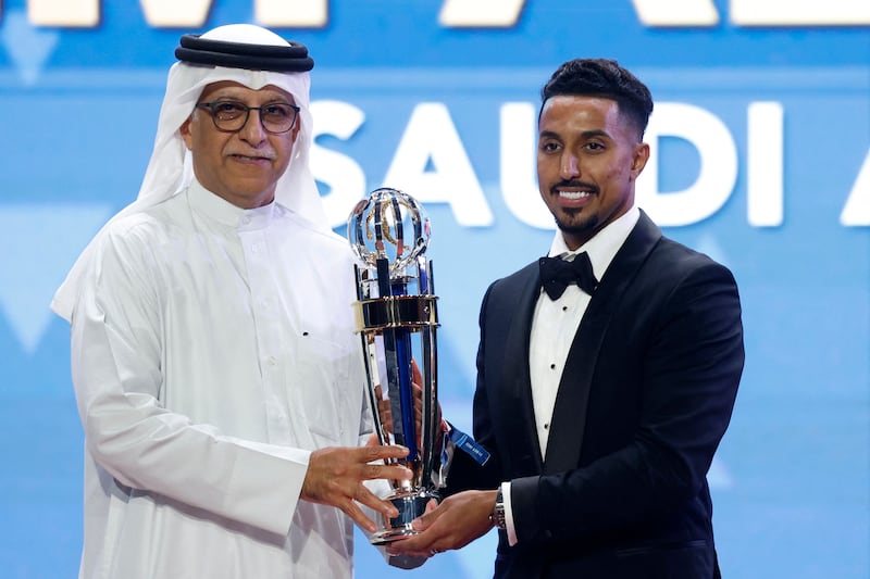 President of the Asian Football Confederation Sheikh Salman bin Ibrahim Al Khalifa presents Saudi Arabia's forward Salem Al Dawsari with the AFC Player of the Year award at the AFC Annual Awards Doha 2022 on October 31, 2023. AFP