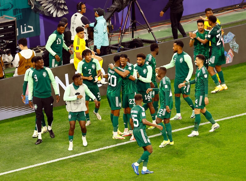 Saudi Arabia's Abdullah Radif celebrates scoring with teammates. Reuters